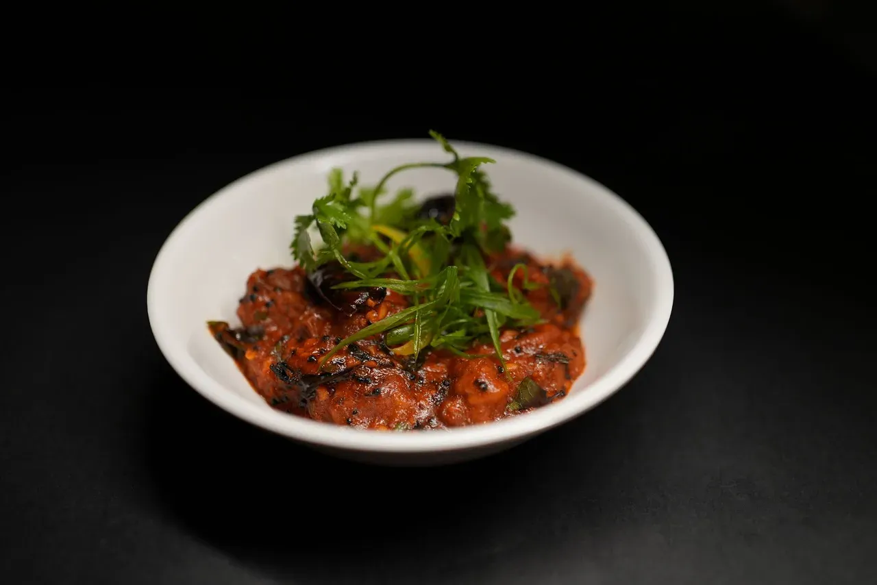 A spicy tomato rougaille-style sauce, the tangy partner to butter bean curry and dholl puri.